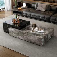 Table basse contemporaine noire et blanche rectangulaire avec plateau en pierre et rangement caché pour ensemble de canapés.