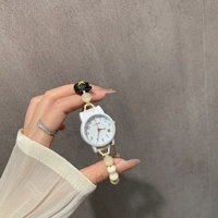 Petite montre-bracelet en alliage pour femme, écologique, artistique, à mouvement à quartz, style dessin animé mignon et de niche, idéale pour les meilleures amies et les étudiantes