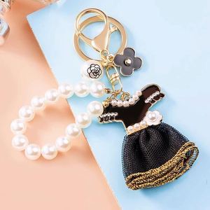 Factory Wholesale Supply Elegant Camellia Pearl Metal Cute Keychain for Women's Girls Bag Pendant and <b>Small</b> <b>Gift</b> - Product Image 1