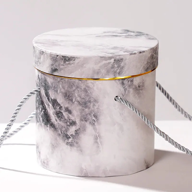 Confezione regalo bianca scatola rotonda nera a forma di cappello fedora in marmo con coperchio e manico