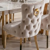 Chaise de salle à manger moderne capitonnée haut de gamme avec anneau de traction tête de lion, revêtement en velours gris, structure en acier inoxydable