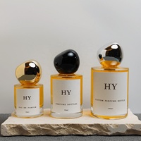 Flacon vaporisateur de parfum en verre cylindrique minimaliste 30ml 50ml 100ml personnalisable avec bouchon en forme de pierre