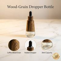 Flacon compte-gouttes OEM personnalisé 30 ml en verre de luxe à grain de bois, avec manchon en bois de café et bulbe en caoutchouc pour bouteilles d'huiles essentielles