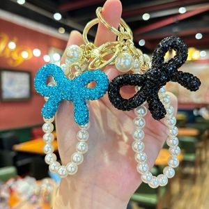 Llavero <span class=keywords><strong>de</strong></span> lazo con diamantes <span class=keywords><strong>de</strong></span> imitación <span class=keywords><strong>de</strong></span> moda al por mayor, colgante <span class=keywords><strong>de</strong></span> cadena <span class=keywords><strong>de</strong></span> perlas estilo coreano inspirado en Chanel para mujer - Product Image 6