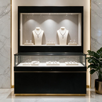 Vitrine de présentation de bijoux de luxe en verre avec cadre doré, armoire à deux portes, éclairage LED intégré, noir mat, pour boutique de détail