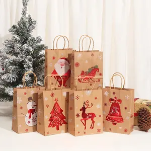Venta al por mayor de oro de Navidad estampado impreso patrón bolsa de papel Kraft regalo con mano fiesta bolsa de Navidad para regalo