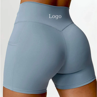 Shorts de sport pour femmes OEM avec logo personnalisé, taille haute torsadée, poches latérales pour téléphone, effet ventre plat et rehaussement des fesses, pour yoga, course à pied et cyclisme