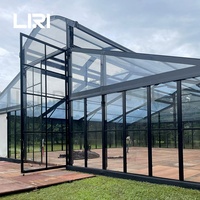 Tentes de réception de luxe pour 100 invités, avec structure noire circulaire, en verre, type serre, marquise, orangerie ou atrium, pour mariages et événements