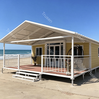 Casa Prefabricada Expandible Tipo Contenedor con Techo de Terraza Totalmente Impermeable, Estándares Australianos, con Barandilla Blanca
