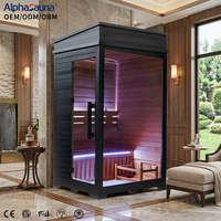 Cabine de sauna intérieure traditionnelle en bois de pruche pour 1 personne avec porte vitrée et banc, cadre noir moderne pour spa haut de gamme à domicile