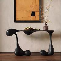 Table d'entrée noire de luxe moderne, console sculpturale créative avec base en forme de goutte pour villa et hôtel