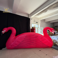 Comptoir de bar gonflable flamant rose décoré pour festivals et mariages, avec plumes réalistes. Montage facile, oiseau gonflable pour exposition en bord de lac.