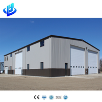 Almacén de estructura de acero de gran capacidad con vigas Q355B y muro cortina para almacenamiento de maquinaria pesada