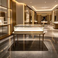 Vitrine de présentation de bijoux haut de gamme en verre avec cadre doré personnalisé, éclairage LED intégré et tiroir, pour boutique de détail
