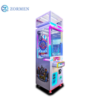 Zormen Máquina de grúa de una sola garra mini con diseño de mapache, gabinete luminoso, operada con monedas, juego de venta sorpresa para fiestas