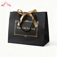 Sac cadeau de luxe en papier noir mat avec logo de votre marque imprimé sur mesure, estampage à chaud doré, poignées en coton et ruban, pour vêtements