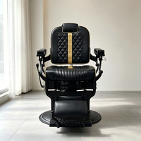 Fauteuil de Barbier Rétro Noir avec Finition Dorée, Hydraulique, Inclinable, en Cuir, Appuie-tête et Repose-pieds Ajustables, Vente en Gros pour Salons de Coiffure
