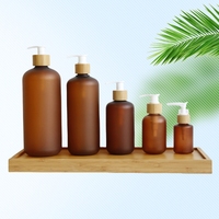 Nouveau modèle de bouteille en plastique PET ambré givré avec logo personnalisé et pompe à lotion en bambou pour l'emballage de lotion corporelle