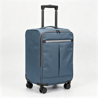 Valise souple pliable à roulettes en tissu bleu avec poches organisatrices frontales, poignée télescopique et protections d'angle