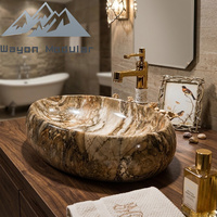 Lavabo ovale en céramique à texture marbre naturel de luxe, lavabo artistique à poser sur comptoir pour projets hôteliers et villas haut de gamme