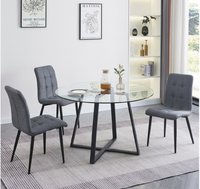 Ensemble de table à manger moderne de luxe avec chaises en tissu gris, structure en fer, plateau rond en verre écologique pour salle à manger et hôtellerie