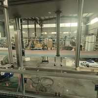 Machine de remplissage automatique à 6 têtes pour liquides (20 kg), avec 6 buses et levage servo, type pesage entièrement automatique