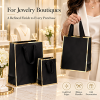 Sacs cadeaux en papier spécial noir et or avec poignées en ruban pour emballages de luxe de bijouteries et boutiques de détail