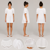 Robe courte blanche pour femme, coupe trapèze, avec col festonné à œillets, manches bouffantes et poignets à œillets
