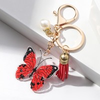 Vente en gros porte-clés personnalisé imprimé de luxe fermoir mousqueton perle papillon pendentif style dessin animé sac voiture acrylique porte-clés gland
