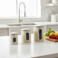 Juego de 3 recipientes metálicos minimalistas BX con ventana transparente para almacenamiento de artículos de cocina y alimentos, con tapas de estilo técnico con logo.