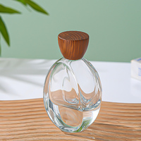 Flacon de parfum ovale transparent personnalisé de luxe 100 ml, flacon d'eau de Cologne à fond épais, bouchon en bois, vaporisateur de parfum