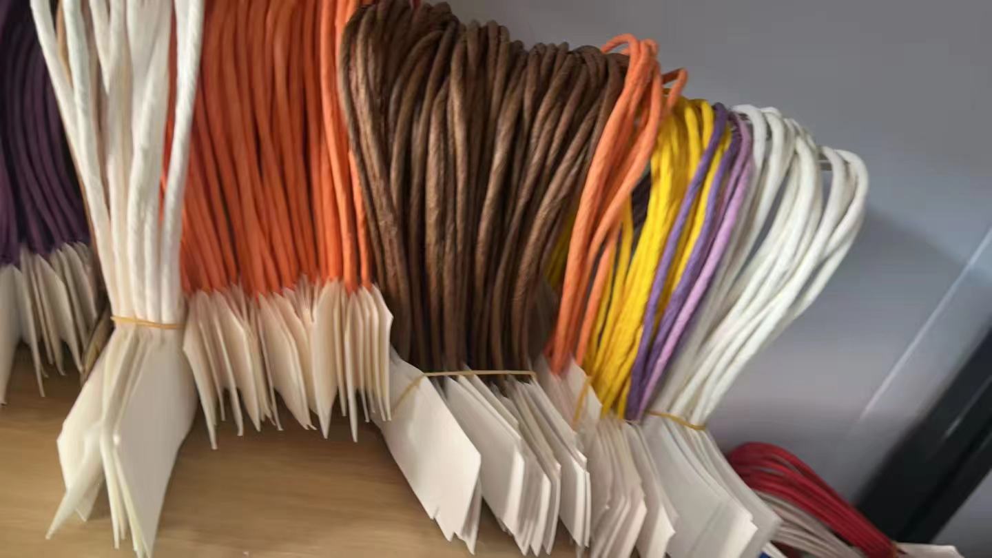 Various-sized handles for shopping bags made from knotted paper ropes