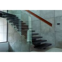 Escalier Prima en acier au carbone avec garde-corps en verre pour villa, hôtel, escalier courbé commercial