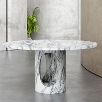 Table de salle à manger ronde en marbre avec base découpée en ellipse, sculptée à la main en pierre massive, pour un intérieur de maison haut de gamme