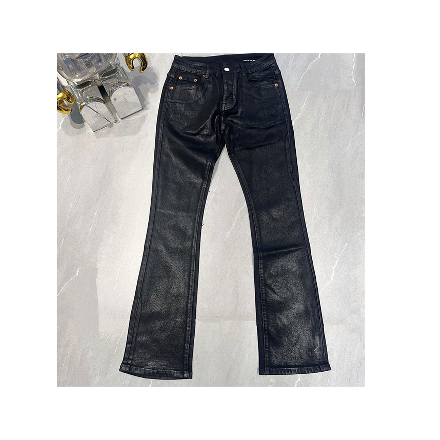Black wax coated boots with cut denim.