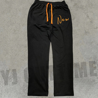 Pantalon de jogging évasé pour homme en molleton bouclette, délavé soleil, avec patch brodé et effet usé