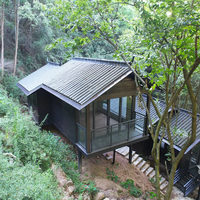 Maison en bois contemporaine avec un design géométrique et des murs en verre, idéale pour un hôtel boutique avec vue sur la mer ou la forêt