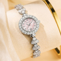 Nouvelle montre-bracelet de luxe pour femme, cadran en nacre, lunette entièrement pavée de strass, montre-bracelet à quartz pour femme, idéale comme cadeau de mariage