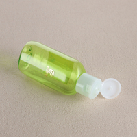 Flacon cosmétique transparent vert en PET de 30 à 300 ml avec bouchon à clapet blanc pour emballage de shampoing et revitalisant – Vente en gros