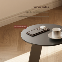 Table basse ronde moderne avec plateau en métal et structure en acier, design minimaliste mobile pour salon et salle à manger