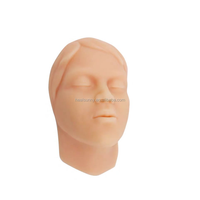 Tête de mannequin d'entraînement pour injections faciales en silicone souple, avec os et emplacements des vaisseaux sanguins sur la moitié du visage