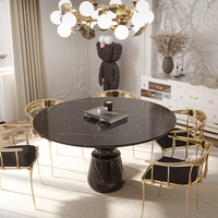 Table à manger ronde en marbre noir de luxe avec base sculpturale artisanale pour une élégance intérieure et extérieure