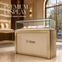 Vitrine d'îlot à bijoux en or brossé avec tiroirs de rangement, comptoir de présentation de bijoux en verre trempé à LED pour boutique de luxe