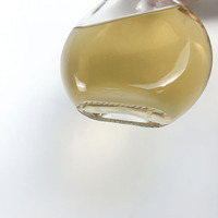 Bouteille à liqueur ronde en verre à base épaisse et col long