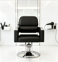 Chaise de salon professionnelle pour coiffeur, en cuir PU noir de luxe, avec repose-pieds en métal et accoudoirs réglables hydrauliquement.