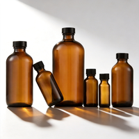 Vente en gros de bouteilles en verre rondes de type Boston de plusieurs tailles avec bouchons à vis noirs pour l'emballage d'huiles essentielles et d'extraits végétaux