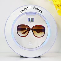 Présentoir à Lunettes Magnétique Flottant Rotatif Moderne en Plastique Poli avec Éclairage LED pour Personnalisation de Design