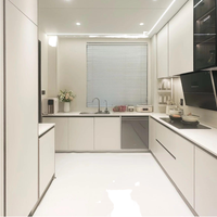 Armoires de cuisine blanches sans poignées, plan de travail en quartz à panneaux plats, évier encastré, éclairage LED, cuisine moderne minimaliste
