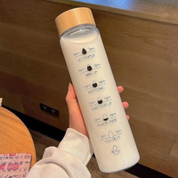Bouteille d'eau transparente en verre borosilicate naturel moderne de 16 oz et 35 oz avec couvercles en bambou pour les voyages et le camping
