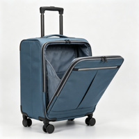 Valise souple pliable à roulettes en tissu bleu avec poches organisatrices frontales, poignée télescopique et protections d'angle